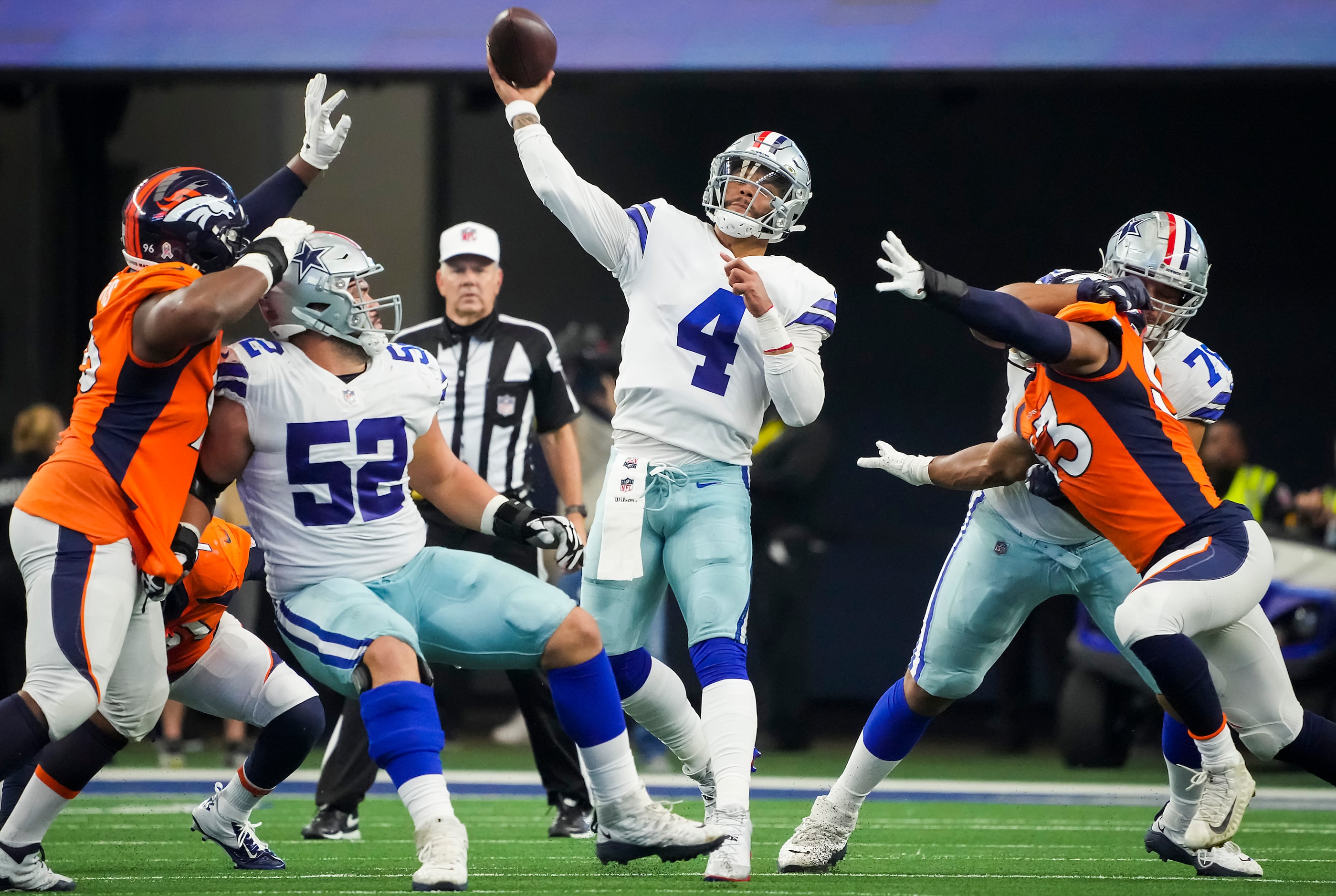 Dallas Cowboys quarterback Dak Prescott (4) throws a pass as guard Connor Williams (52) and...