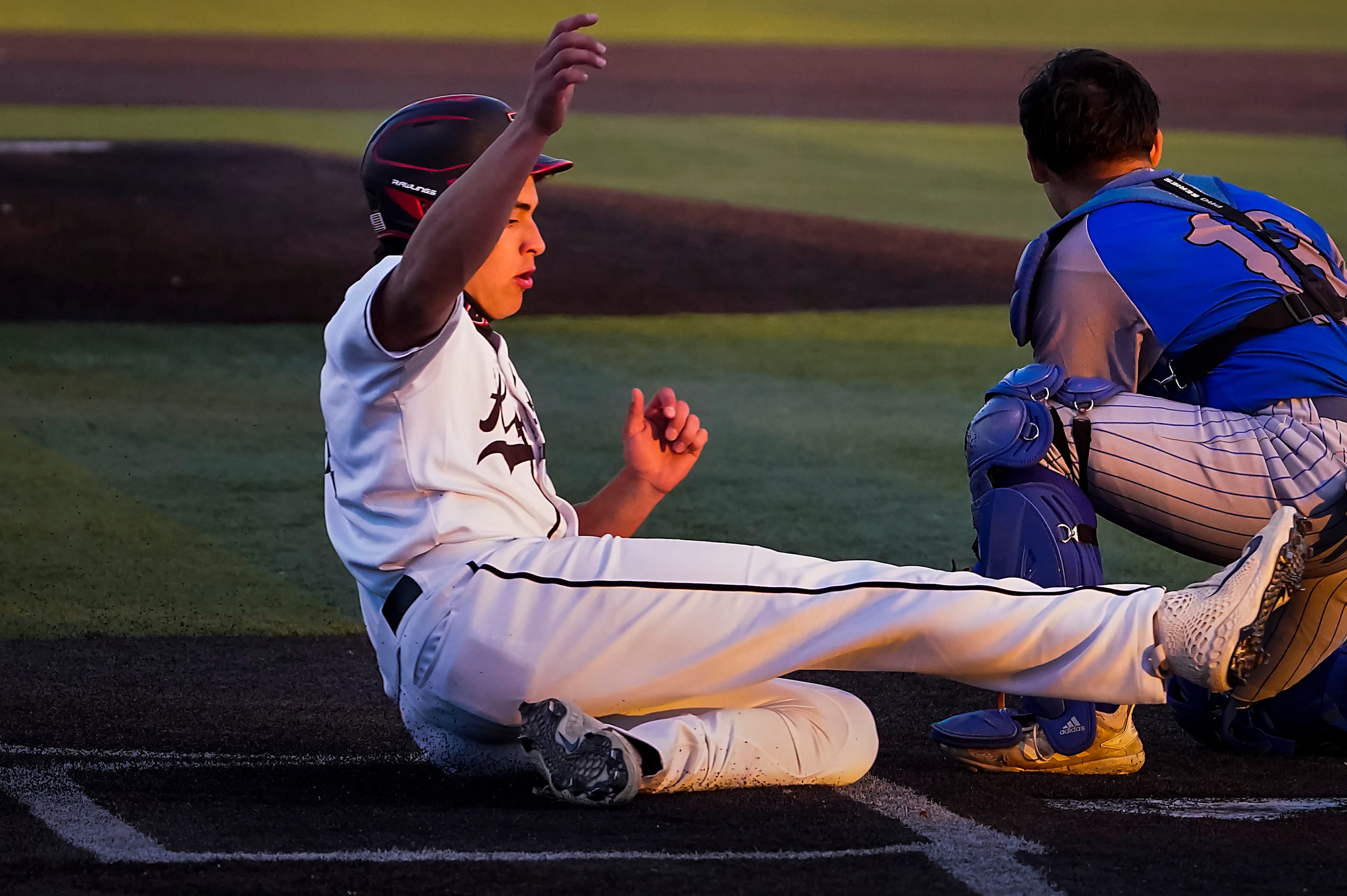 Rockwall-Heath’s Matthew Witt scores ahead of a tag vrom North Mesquite catcher Chris Cobos...