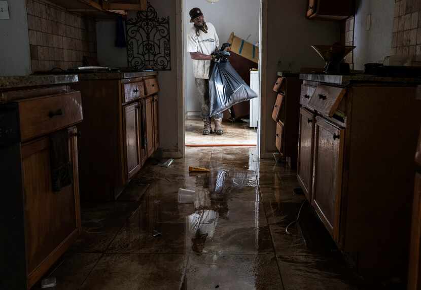 Ron Hardy helped clean out  Michael Boyd's flooded  home on Wednesday, Aug. 30  in Houston....