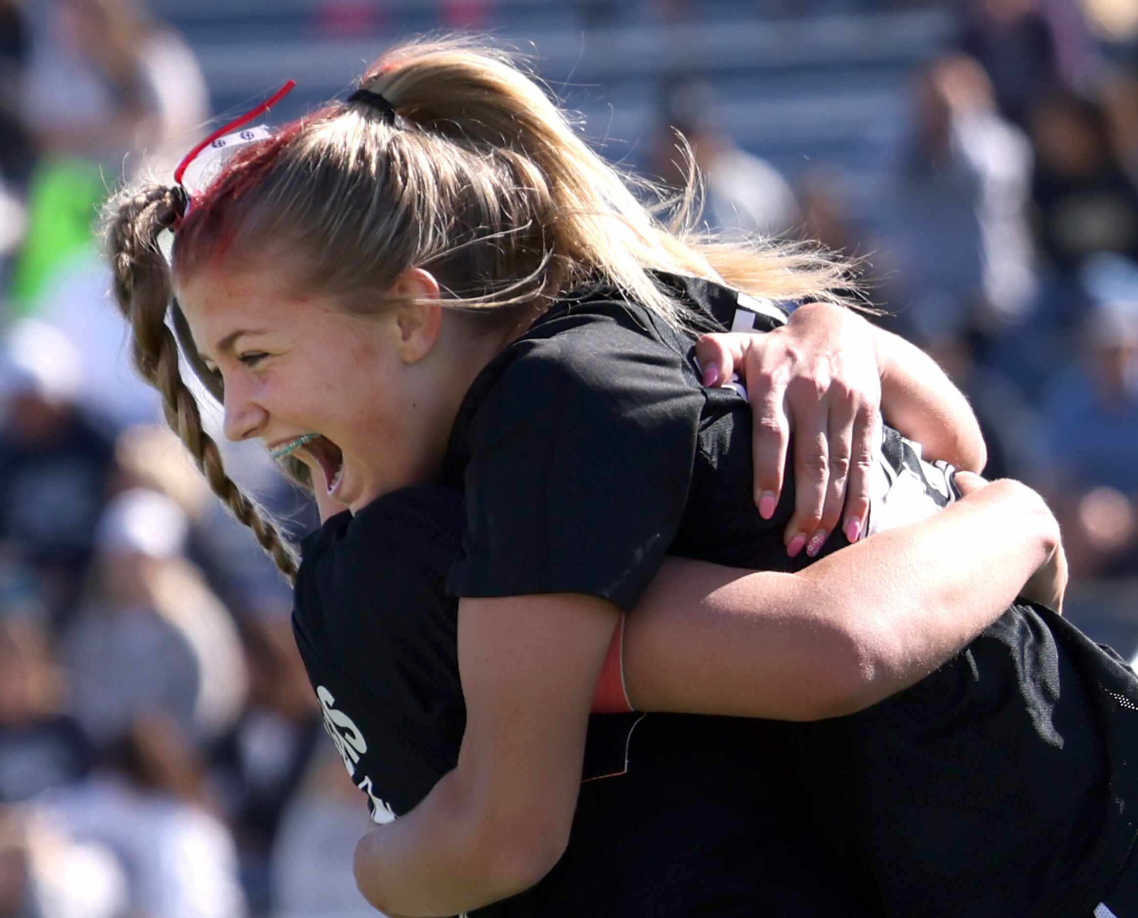 Colleyville Heritage forward Addison Shimmick (22) receives a celebratory hug from a...