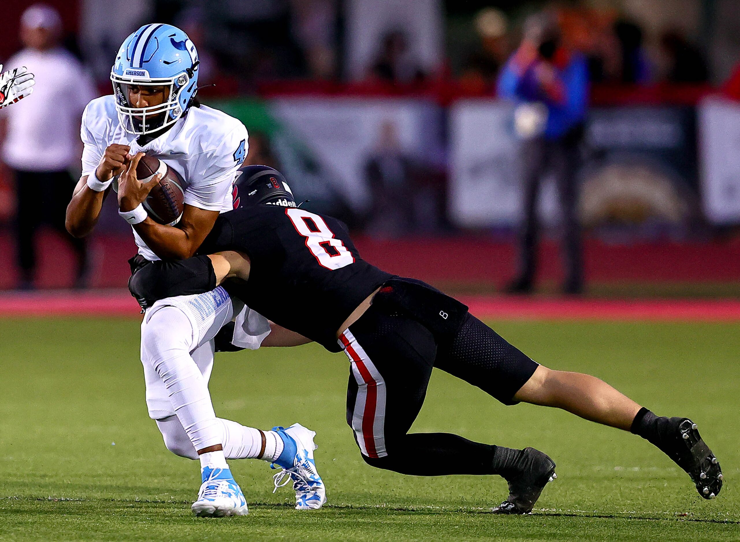 Frisco Emerson quarterback Michael Hawkins (4) gets stopped for a short gain by Argyle...