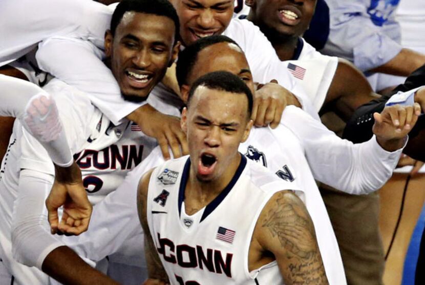 Connecticut Huskies guard Shabazz Napier (13) and other teammates celebrate their 60-54 win...