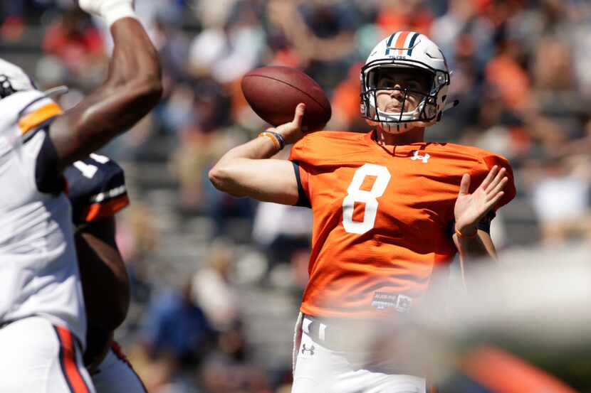 Auburn quarterback Jarrett Stidham makes a throw in the first half of Auburn's NCAA college...