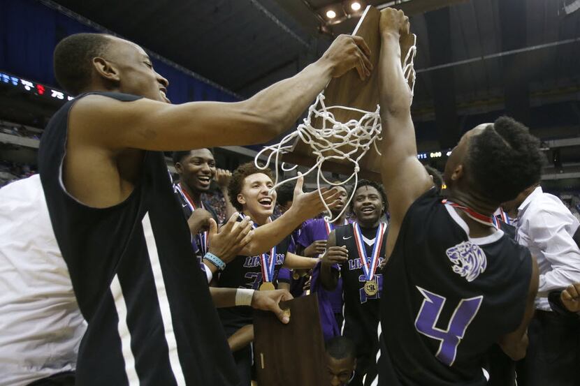 Dallas Lincoln's Kortrijk Miles, left, and Lamarsay Austin (4) celebrate with their team a...
