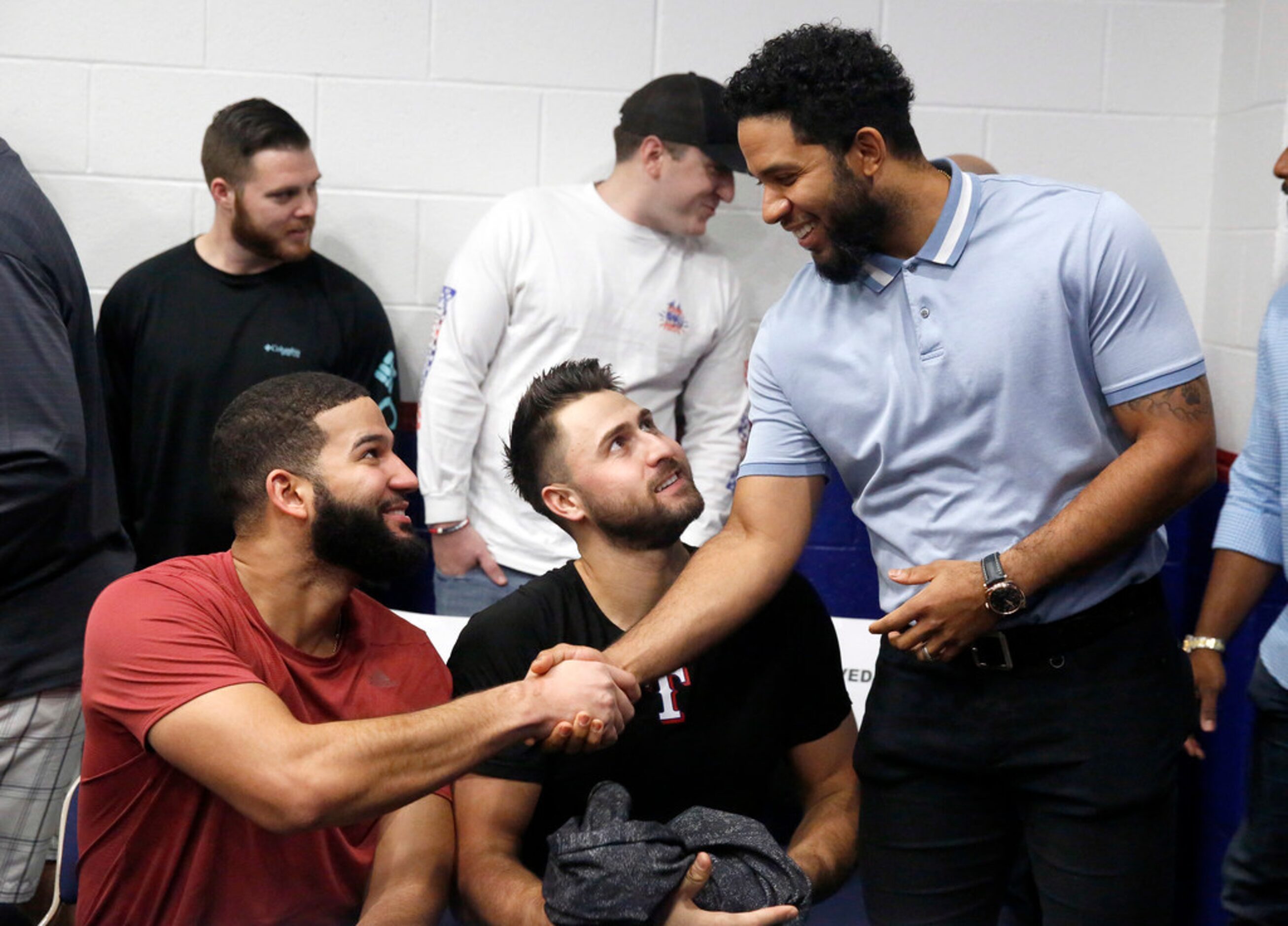 Texas Rangers shortstop Elvis Andrus (right) shakes hands with outfielder Nomar Mazara...