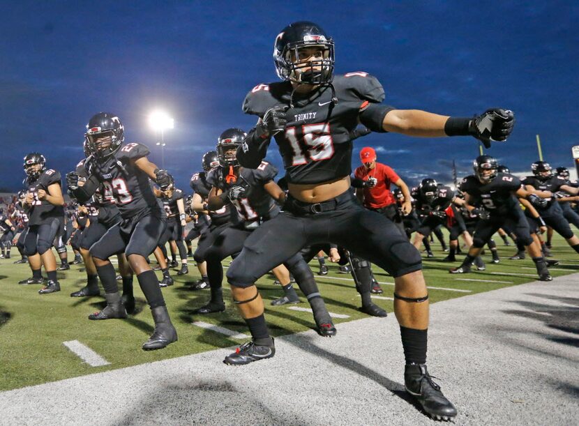 Trinity senior Sampson Tasini (15) leads the team in their  traditional Tongan pre-kickoff...