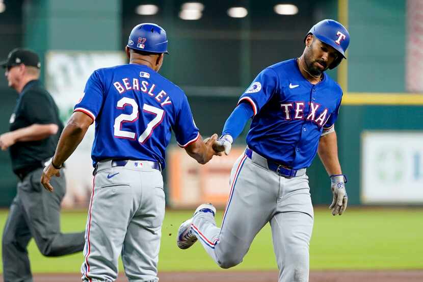 Texas Rangers' Marcus Semien, right, celebrates after his solo home run against the Houston...