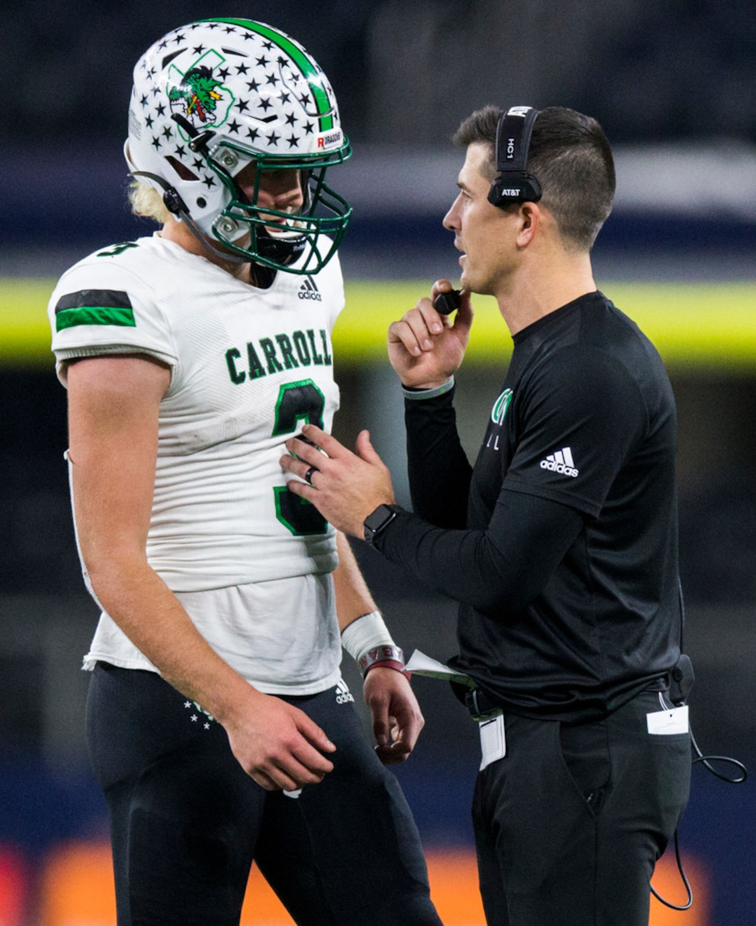 Southlake Carroll quarterback Quinn Ewers (3) talks with head coach Riley Dodge during the...