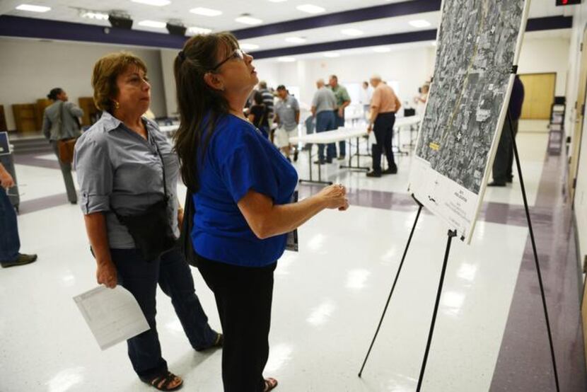 
Mary Breaud (left) and Sherri Sims  look at plans explaining the proposed project. 
