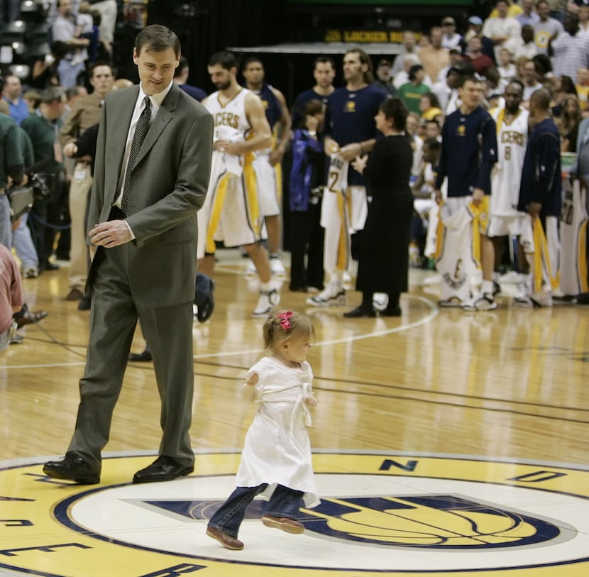 Indiana Pacers coach Rick Carlisle chases his daughter, Abby Carlisle, around center court...