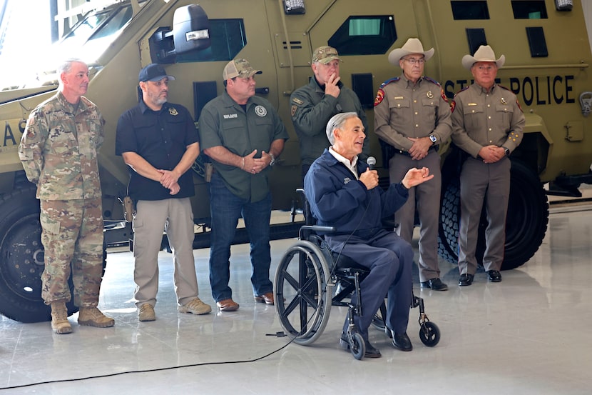 Texas Gov. Greg Abbott, center, speaks, Tuesday, Nov. 26, 2024, in Edinburg, before he...