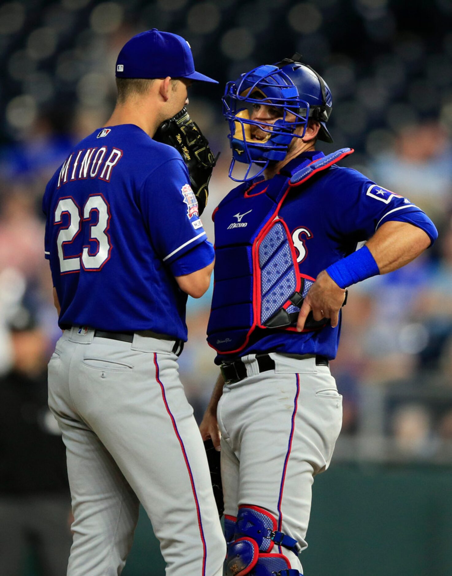 Texas Rangers starting pitcher Mike Minor (23) and catcher Jeff Mathis, right, talk during...