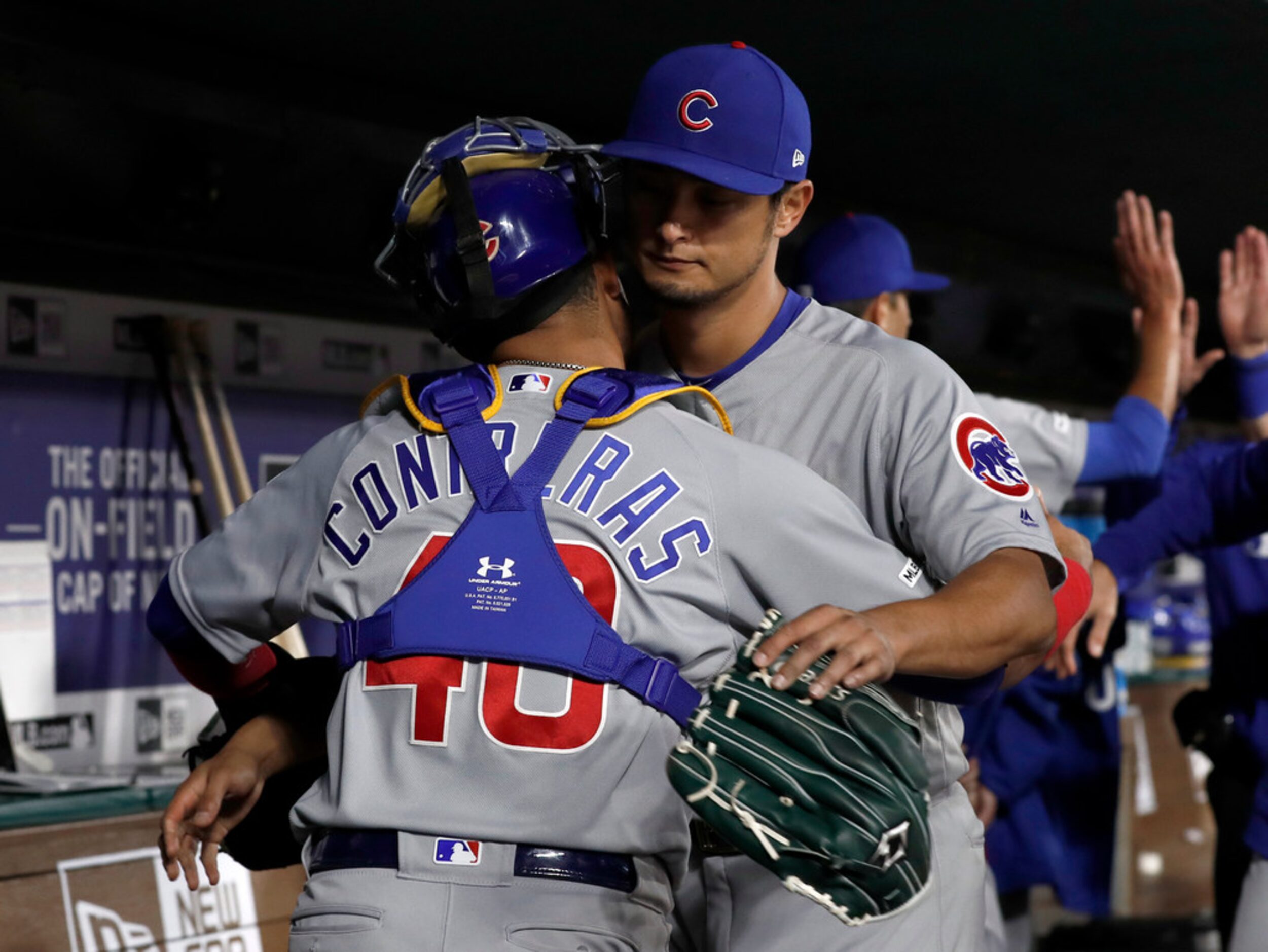 Chicago Cubs catcher Willson Contreras (40) and starting pitcher Yu Darvish greet each other...