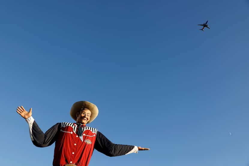 A Southwest Airlines flight passes over Big Tex during the State Fair of Texas at Fair Park...