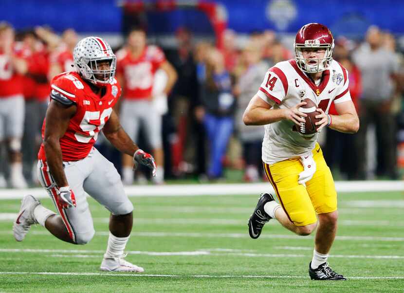 USC Trojans quarterback Sam Darnold (14) scrambles as Ohio State Buckeyes defensive lineman...