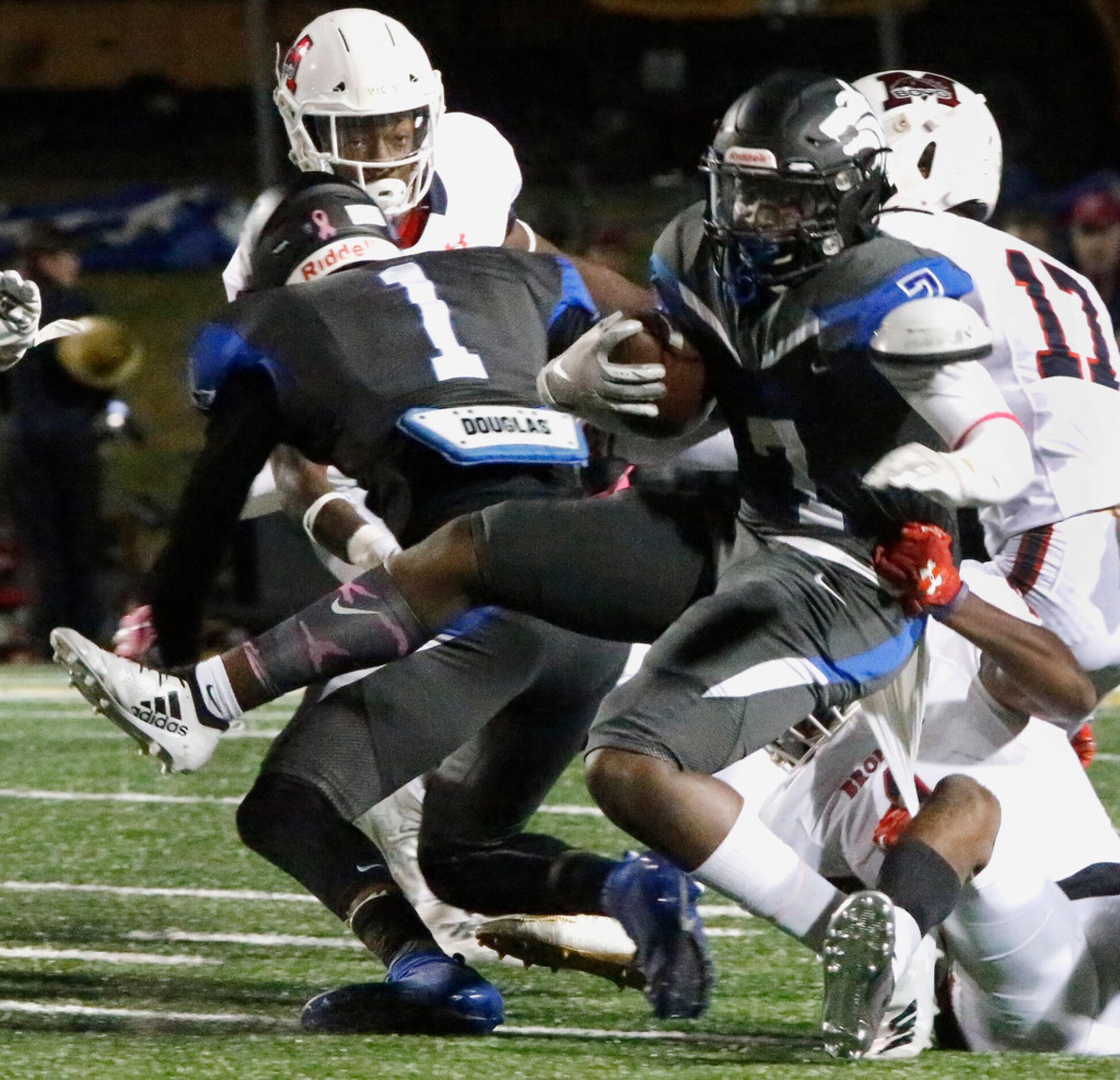 Plano West High School running back Tabron Yates (7) is tackled by McKinney Boyd High School...