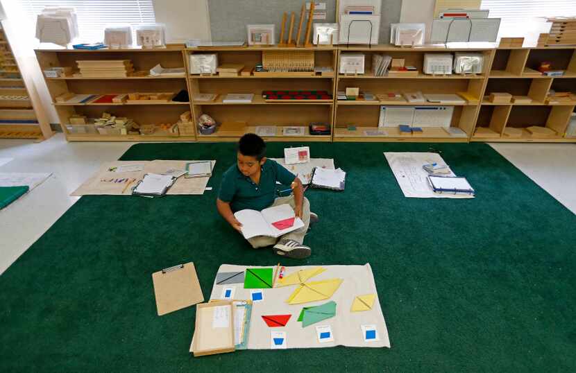 Second-grader Andres Tovar, 7, completes his classwork during a Lower Elementary Dual...