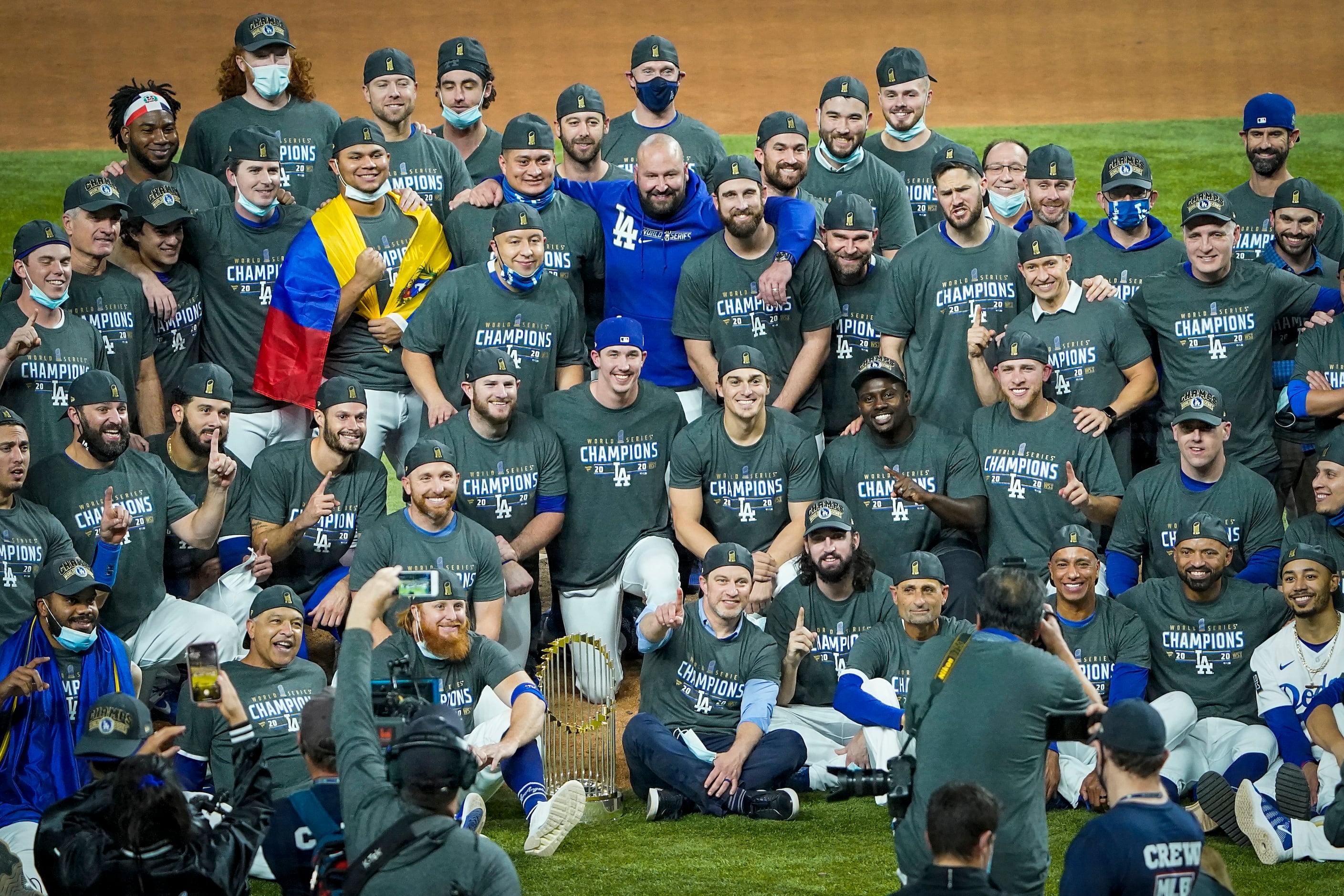 Los Angeles Dodgers players poses for a group photo as they celebrate after defeating the...