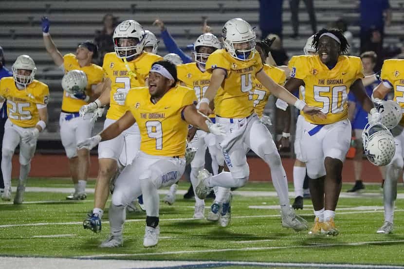 Frisco players storm the field after Mason Stallons kicked a field goal in overtime to beat...