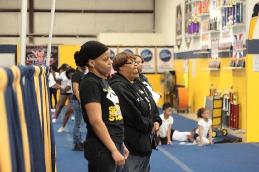 
Michele Epps (middle) watches tryouts for competitive cheer teams at Twister Spirit...