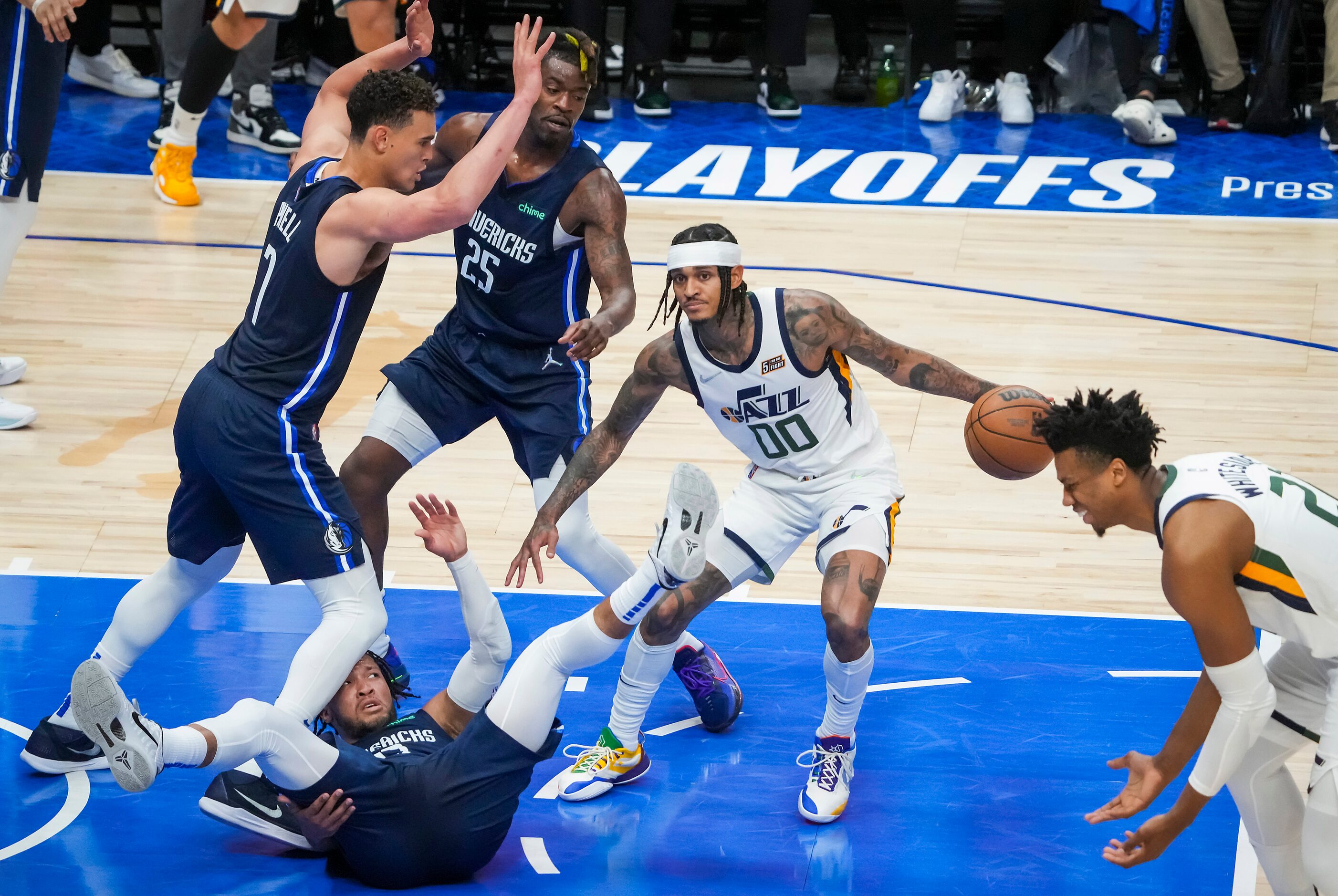 Dallas Mavericks guard Jalen Brunson (13) hits the floor as center Dwight Powell (7) and...