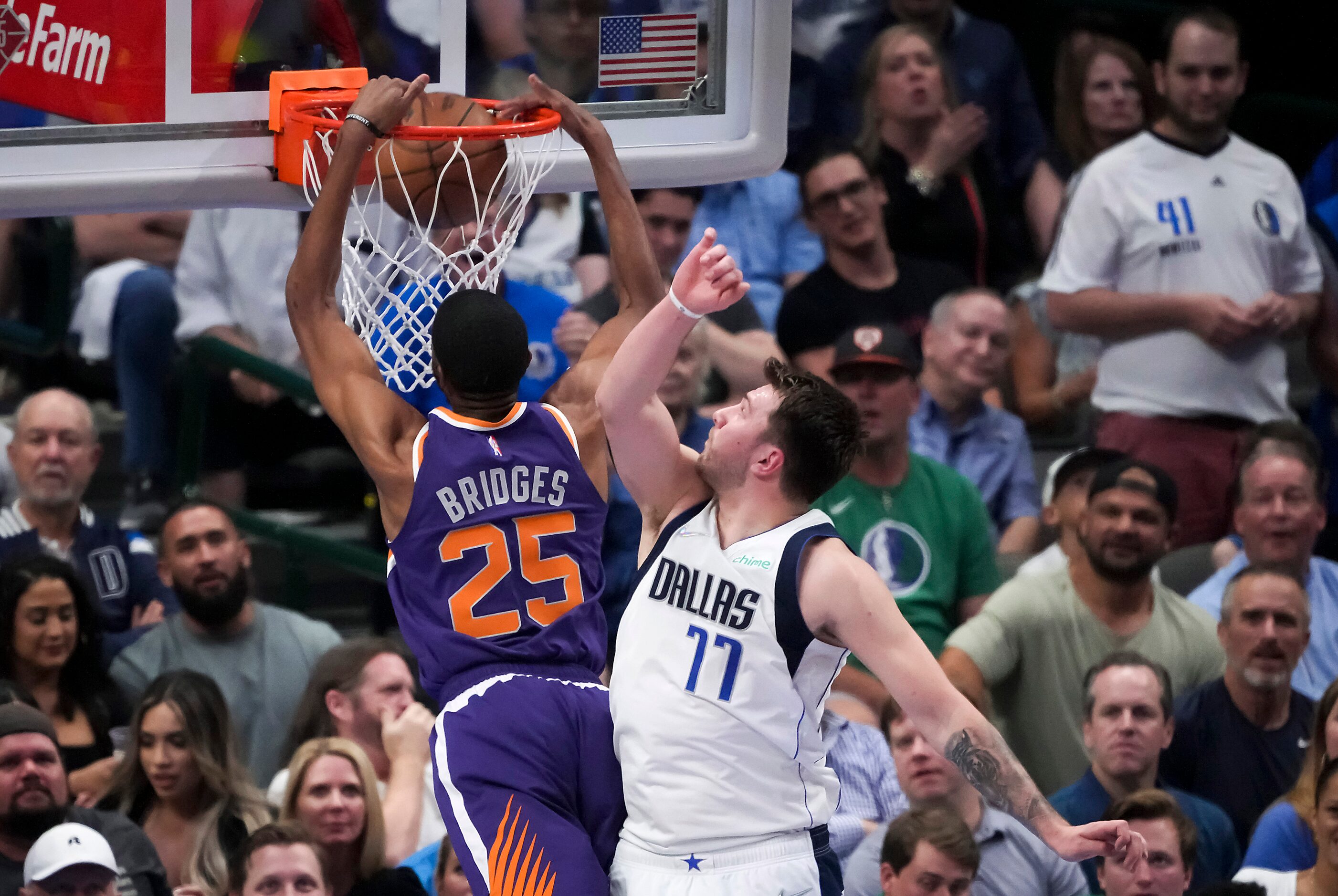 Phoenix Suns forward Mikal Bridges (25) dunks the ball past Dallas Mavericks guard Luka...