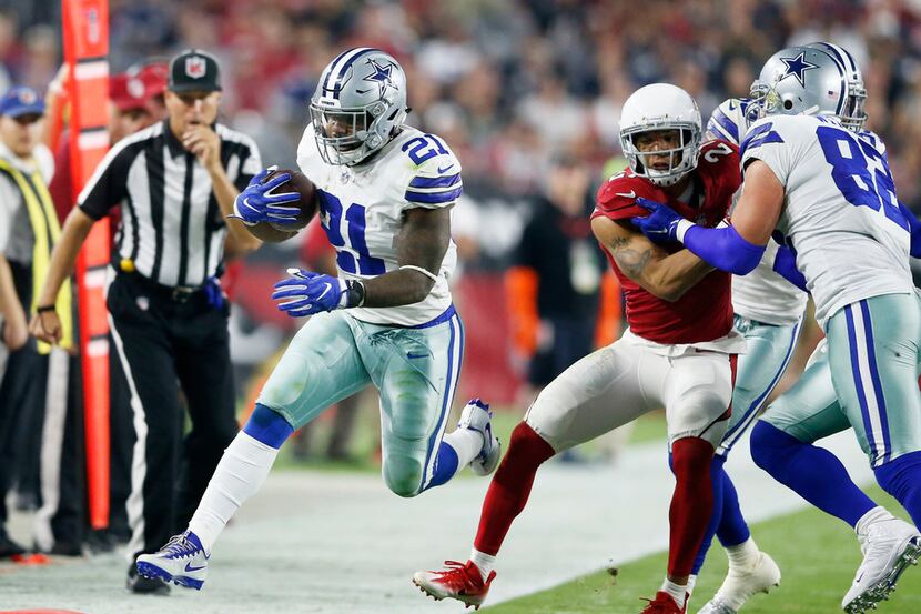 Dallas Cowboys running back Ezekiel Elliott (21) leaps for the first down during the second...