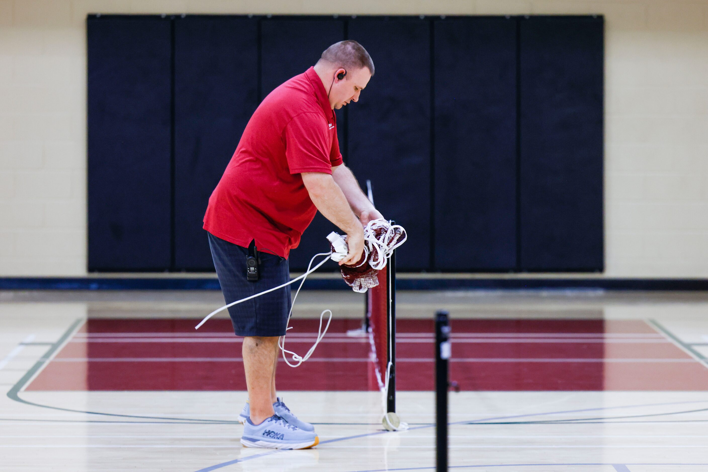 Tom Muehlenbeck Recreation Center coordinator Jason Owen takes off the net after the...