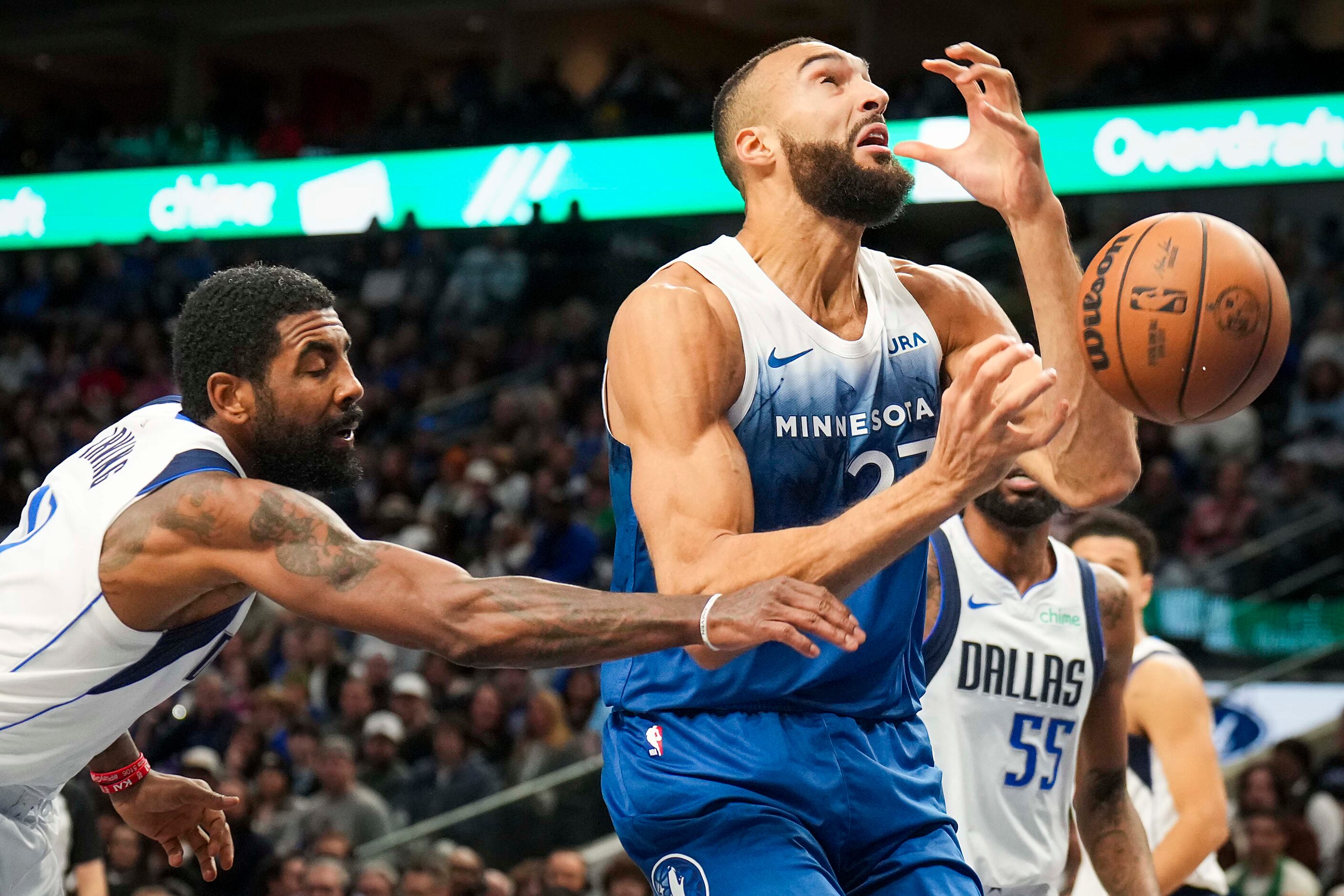 Minnesota Timberwolves center Rudy Gobert (27) is fouled by Dallas Mavericks guard Kyrie...