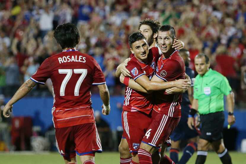 FC Dallas defender Matt Hedges (24), right, celebrates with teammates after heading in a...