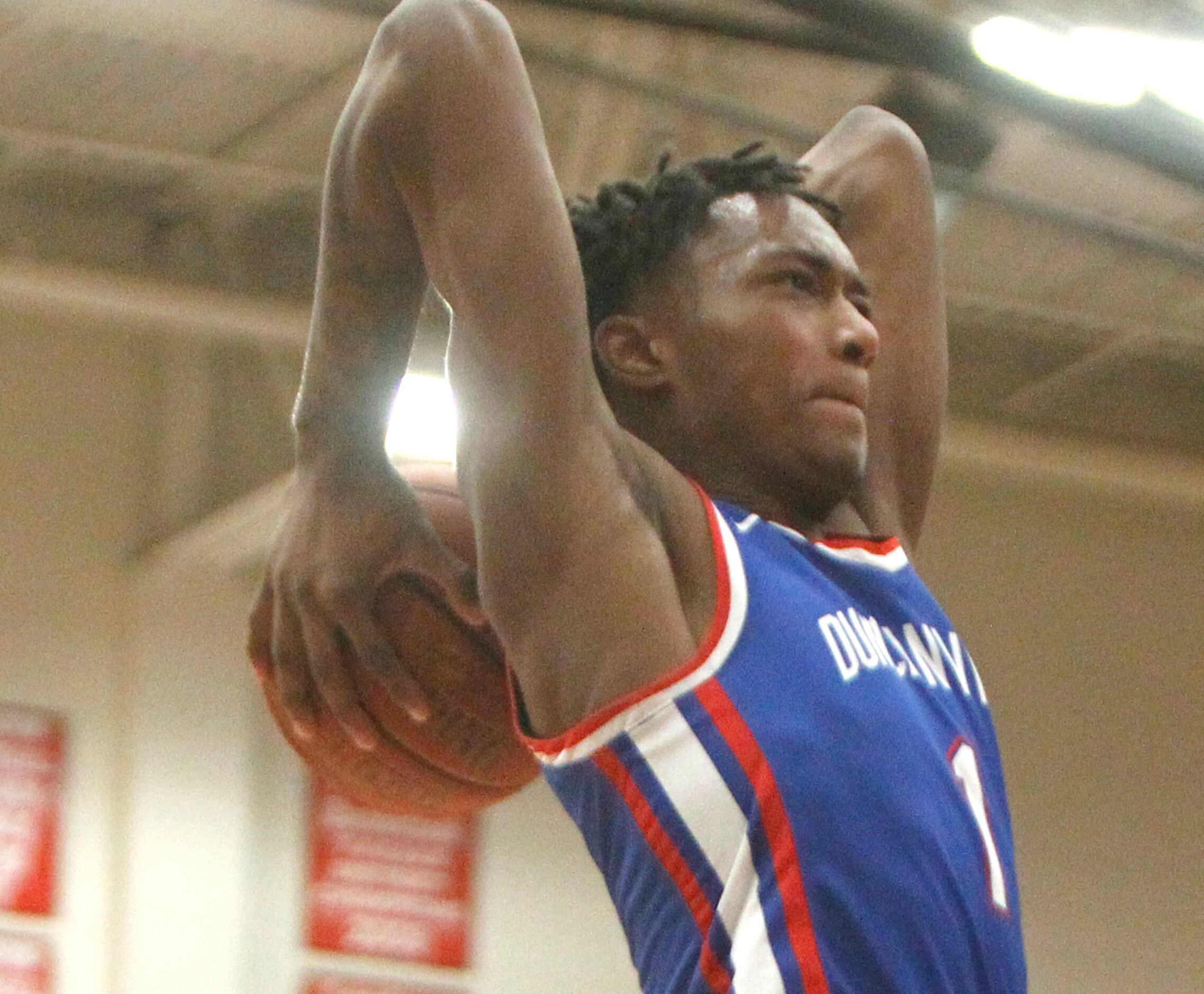 Duncanville forward Ronald Holland (1) skies to the basket to dunk for two of his first half...
