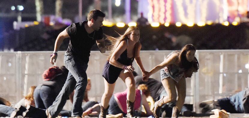 People run from the Route 91 Harvest country music festival after gunfire began on Oct. 1 in...