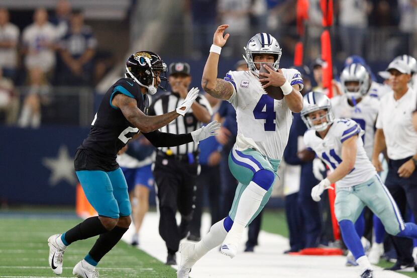 Dallas Cowboys quarterback Dak Prescott (4) rushes up the field for a long run as he is...