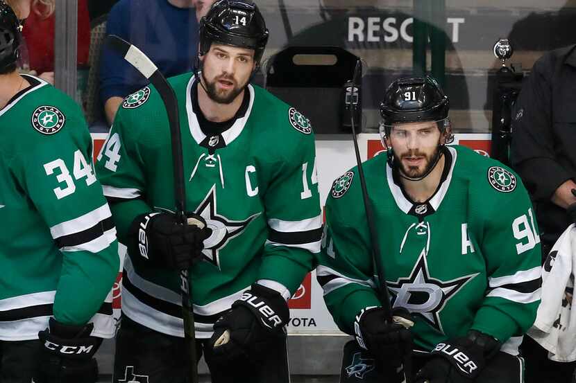 Dallas Stars left wing Jamie Benn (14) and center Tyler Seguin (91) look on from the bench...