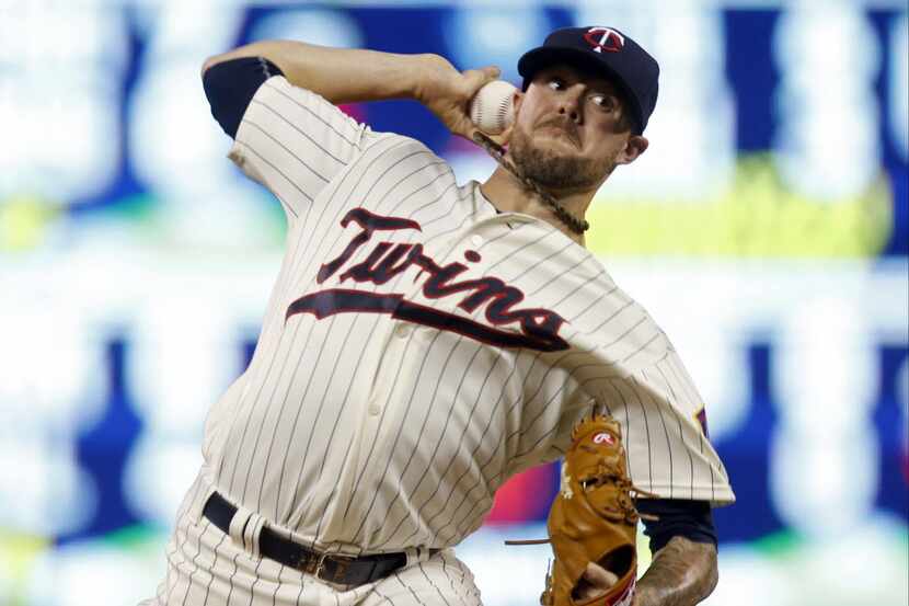 Minnesota Twins pitcher Ryan Pressly throws against the Miami Marlins in the eighth inning...