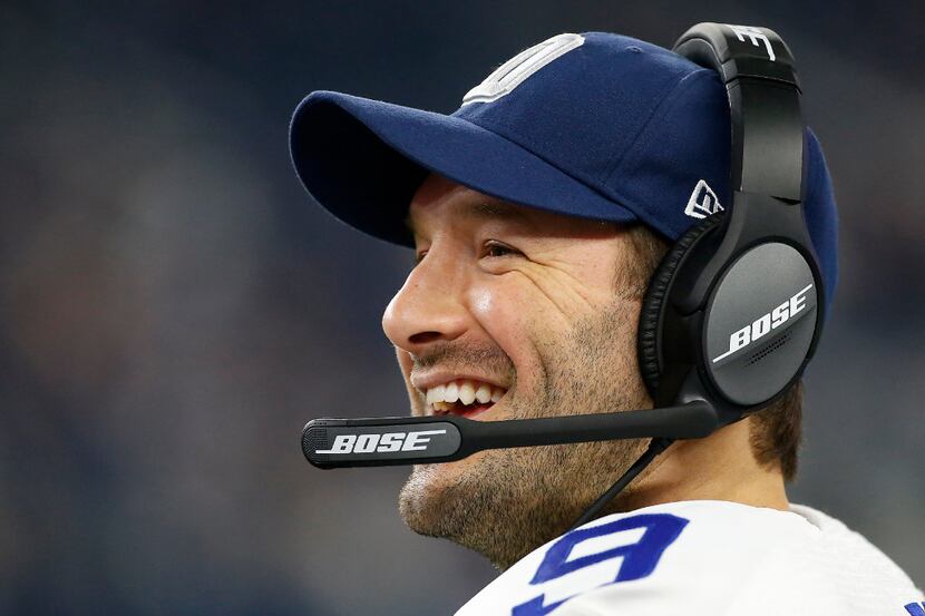Dallas Cowboys quarterback Tony Romo (9) smiles on the sideline during the fourth quarter...