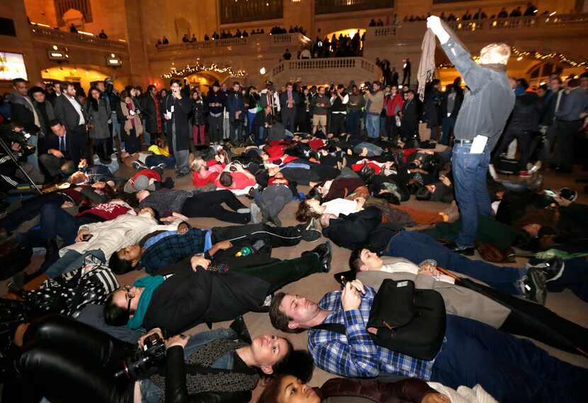 Protesters lie on the ground at Grand Central Terminal after it was announced that the New...