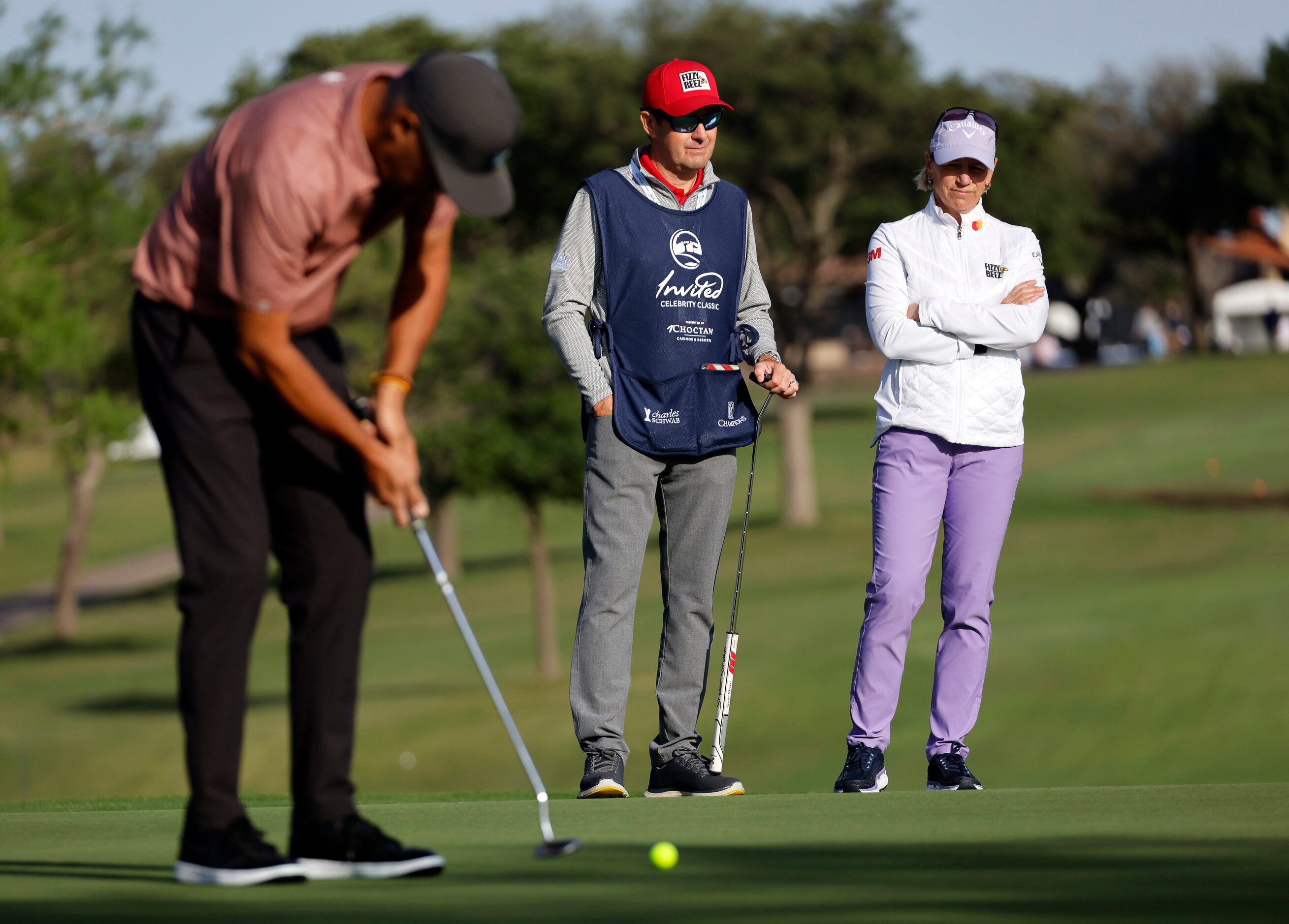 Retired LPGA golfer Annika Sorenstam (right) and her husband and caddie Mike McGee watch as...