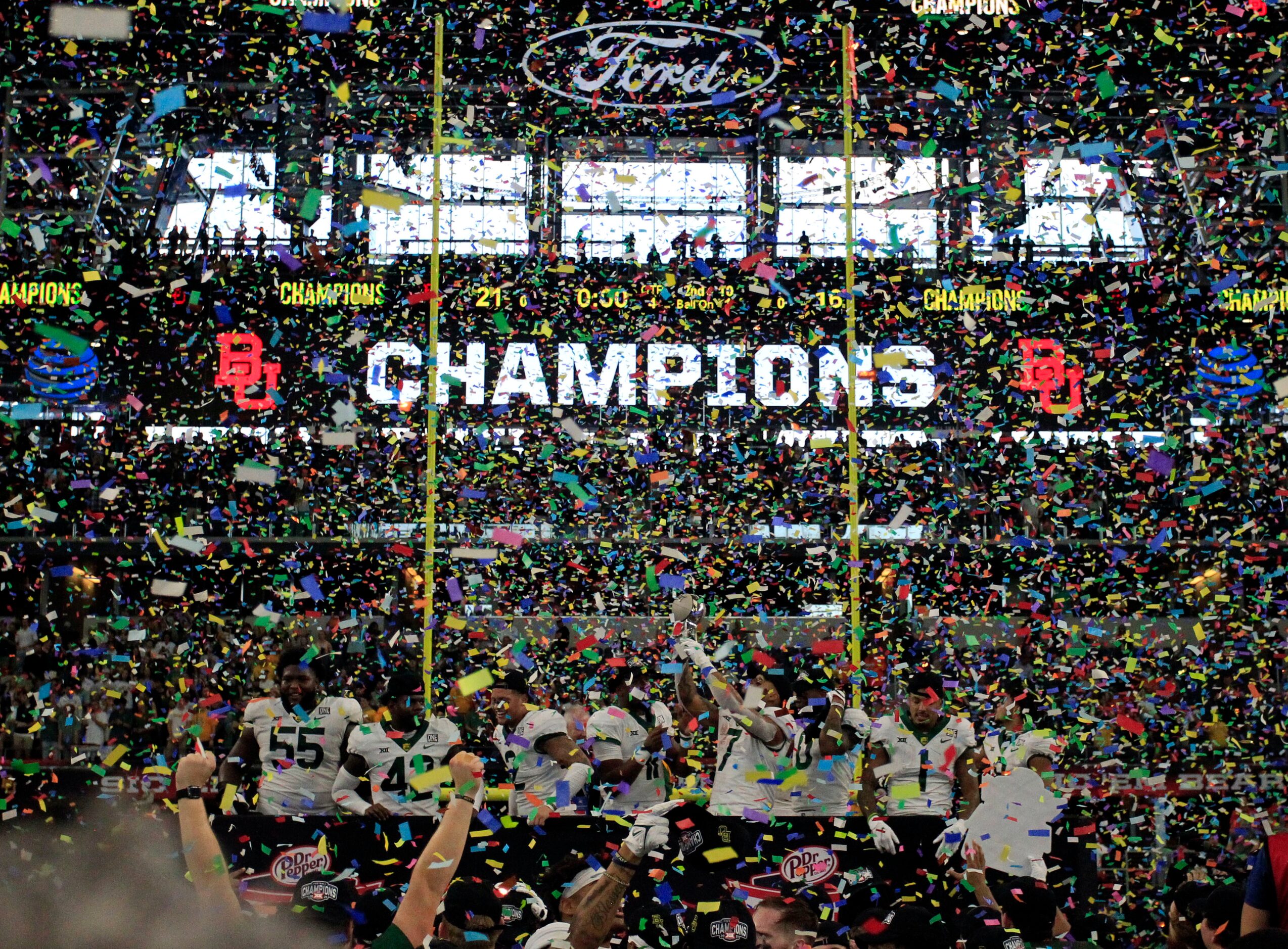 The Baylor Bears football team celebrates in a storm of confetti after their 21-16 win in...