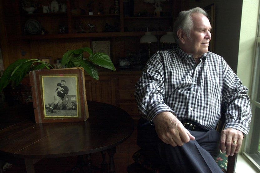 Fred Skidmore Jr. poses at his University Park home with an old photo album of his school...