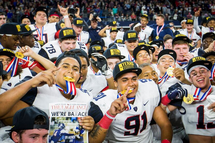 Allen players celebrate after the Eagles 35-33 victory over Lake Travis in the Class 6A...