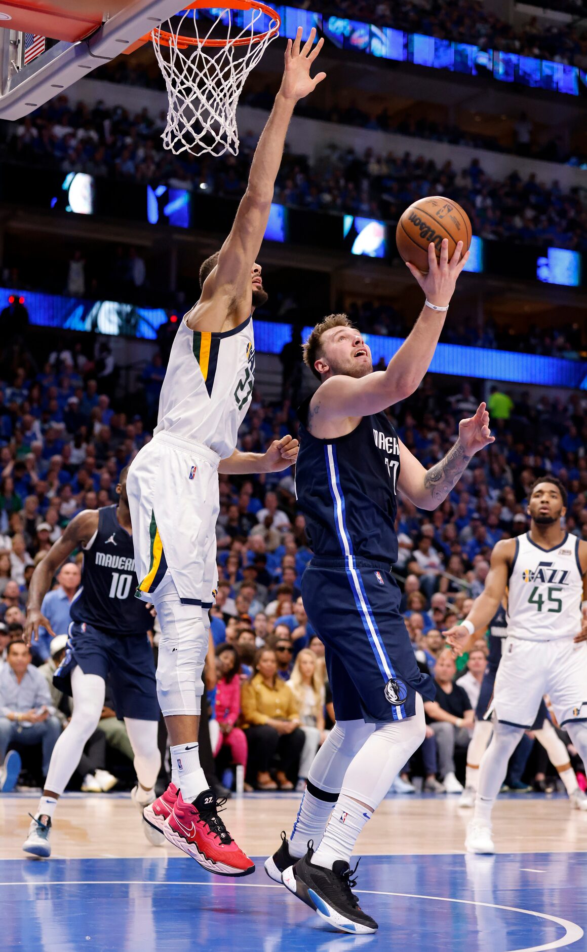 Dallas Mavericks guard Luka Doncic (77) puts up a blind shot as he’s fouled by Utah Jazz...