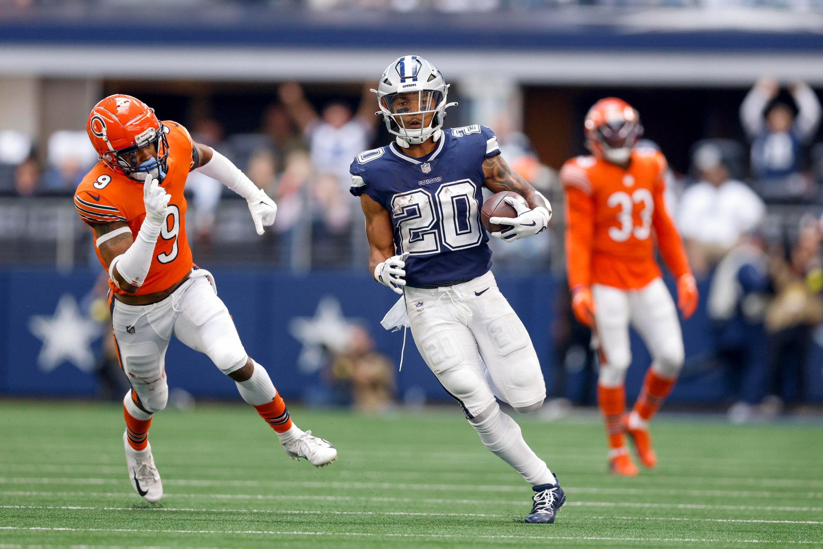 Dallas Cowboys running back Tony Pollard (20) races past Chicago Bears safety Jaquan Brisker...