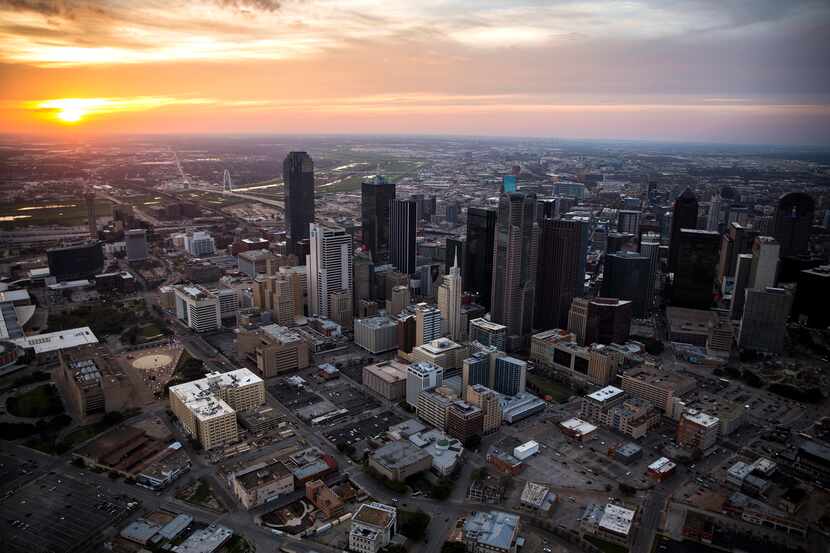 Sun setting behind the downtown Dallas skyline on March 6, 2017.