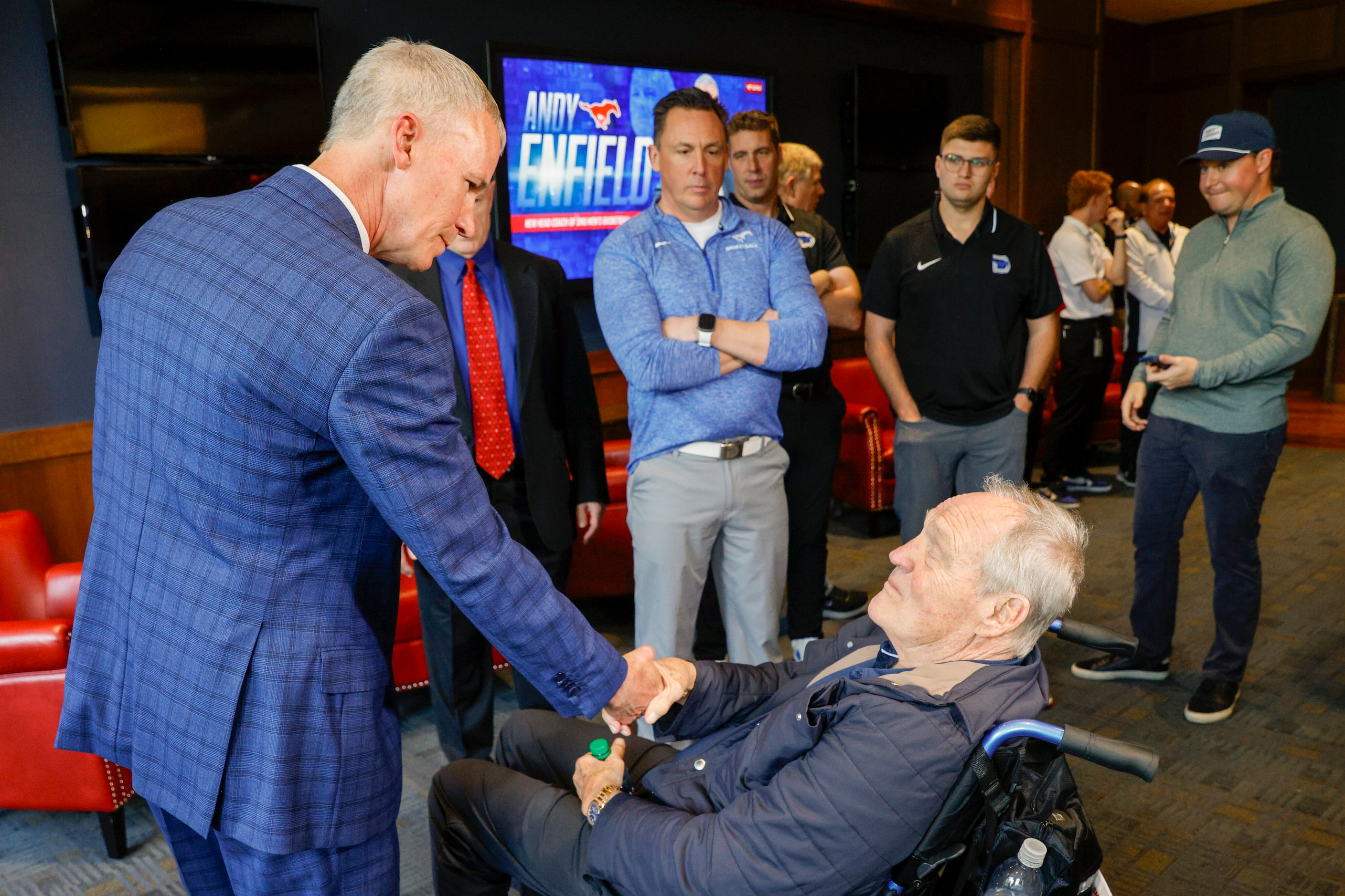 SMU head men's basketball coach Andy Enfield (left) greets alumnus Garry Weber after an...