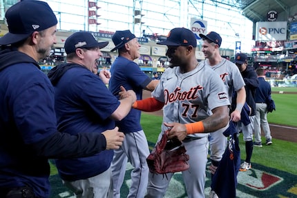 Detroit Tigers' Andy Ibanez (77) celebrates with the team and staff after their 5-2 win...