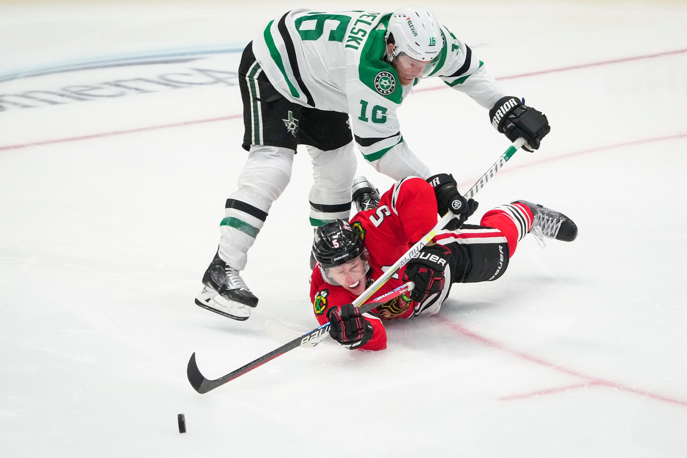 Chicago Blackhawks defenseman Connor Murphy (5) slips to the ice as Dallas Stars center Joe...