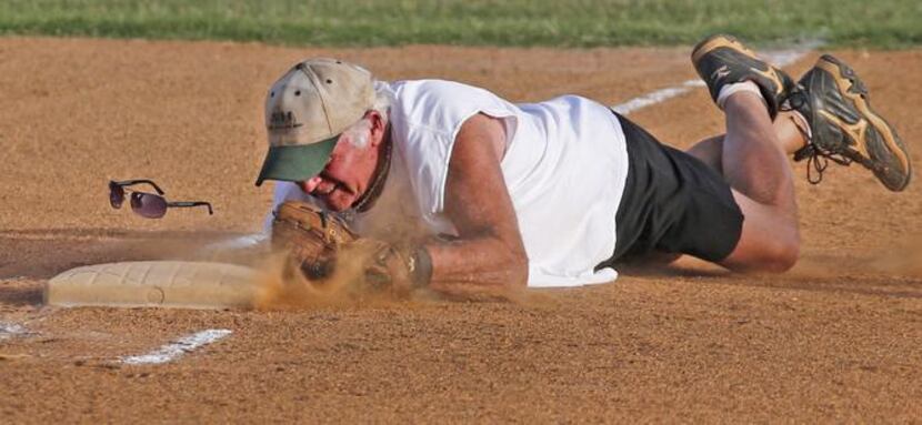 
The third baseman for the team playing against the Greyhounds dives to touch third base for...