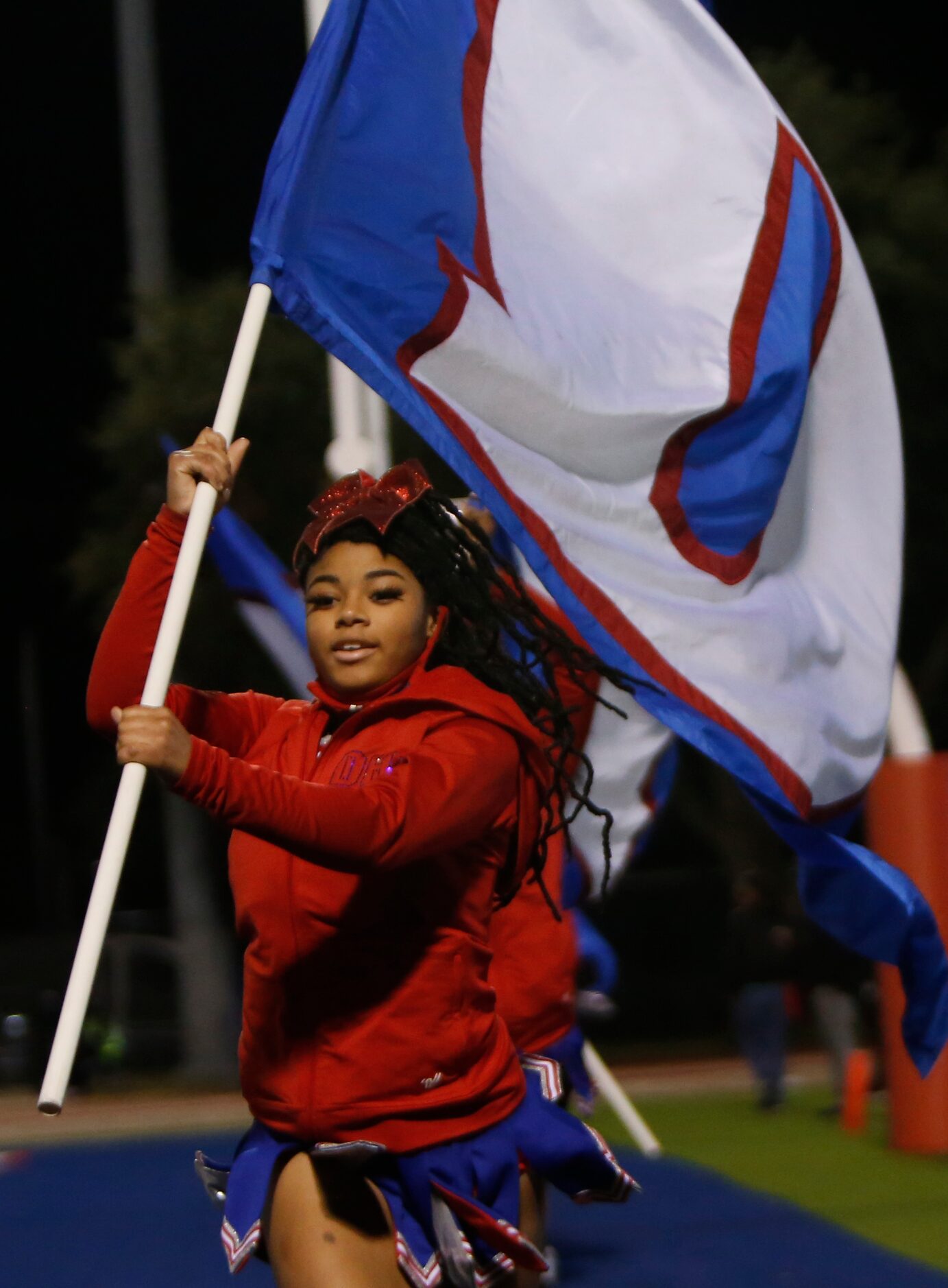 A member of the Panthers flag waving support team races across the end zone following a...