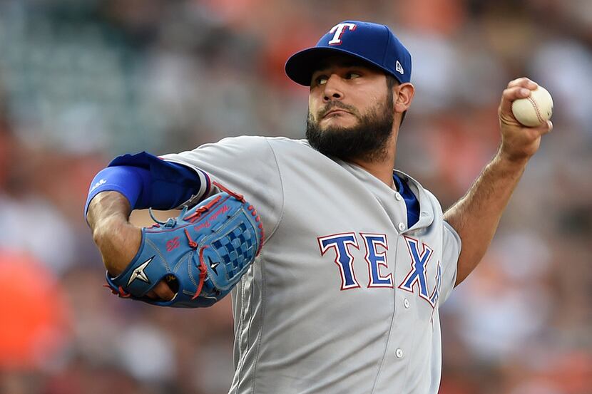 Texas Rangers pitcher Martin Perez delivers against the Baltimore Orioles during the first...